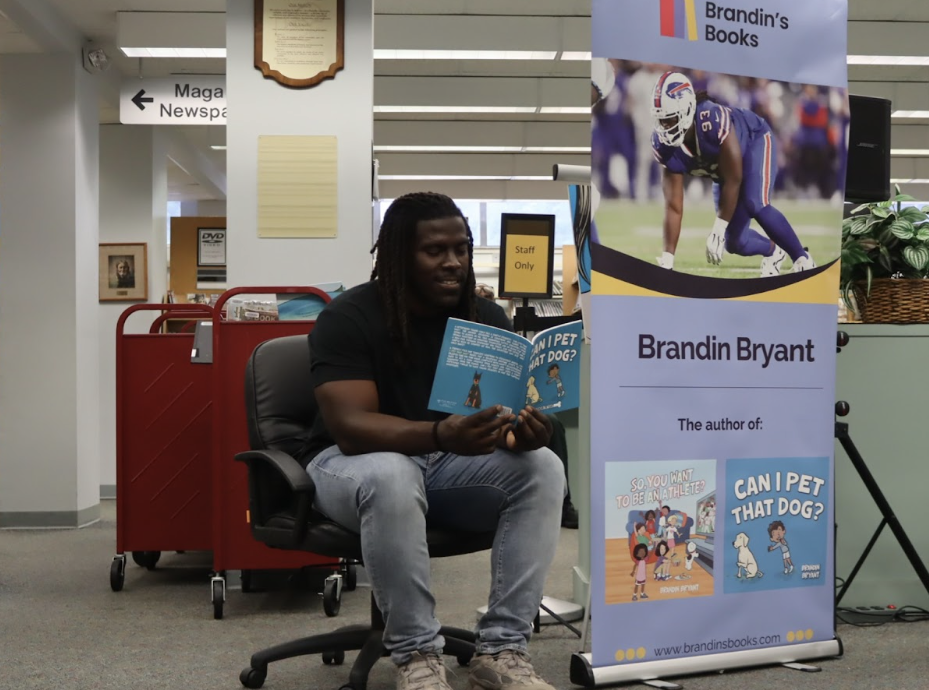 Brandin Bryant, former FAU football player and now published author, reading his sophmore book “Can I Pet That Dog”  to attendees of his public launch party on Aug. 23 at Ethel M. Gordon Oakland Park Library. 